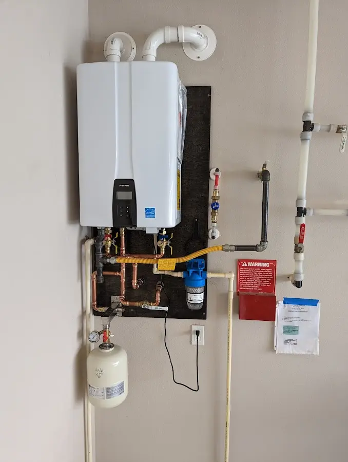 Professional plumber installing copper piping in a Longview Heights home